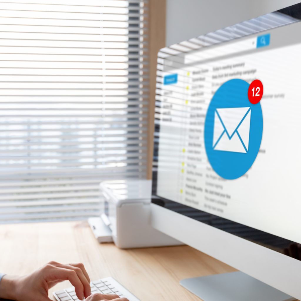 Person checking a crowded email inbox on a desktop computer
